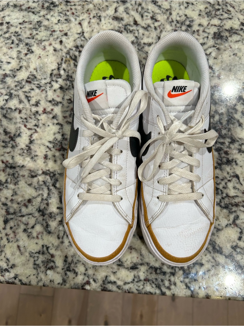 Nike women’s White Sneakers with Black Swoosh and Gold Trim